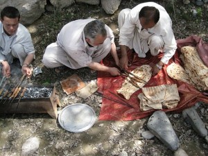 Afghan locals preparing lamb kebabs, made immediately following a sheep slaughter.